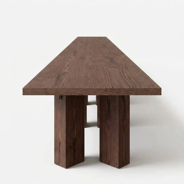Mesa de Comedor Diadem para 12 sillas en nogal con bases de pedestal monolítico en vista frontal de estudio | LEMICH Atelier